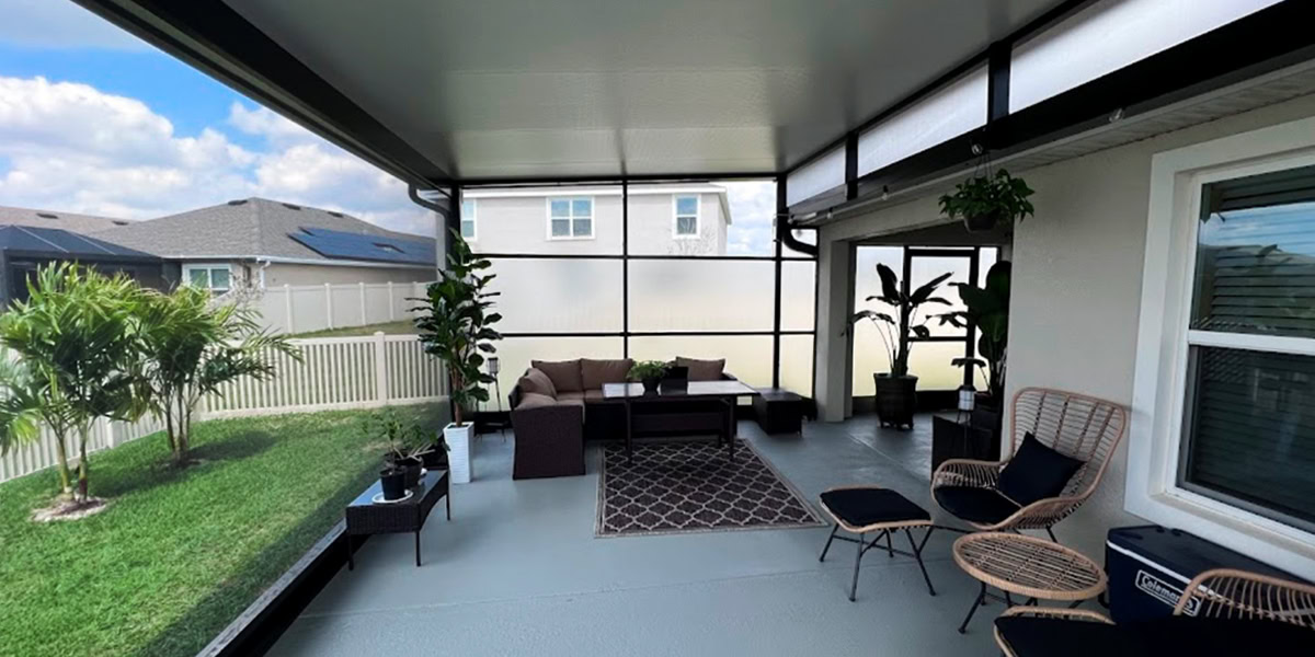 Pombos_Tampa-Bay-Florida-Screen-Enclosures_Sticky_Screened-In-Porch Cozy screened-in porch with furniture for relaxing and entertaining